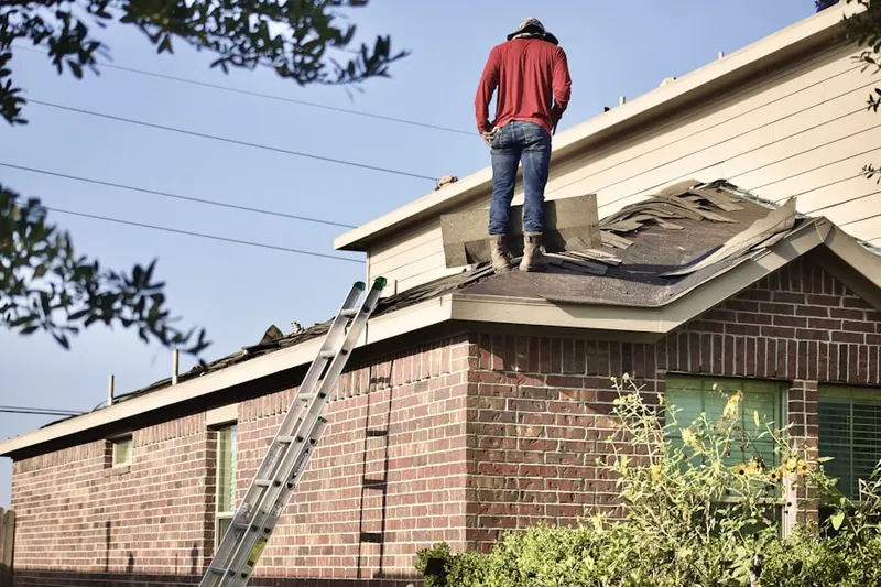 Professional roofer working on a residential roof in Interlocken